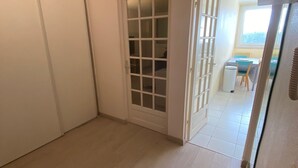 A room with a sliding door leading to a dining area.