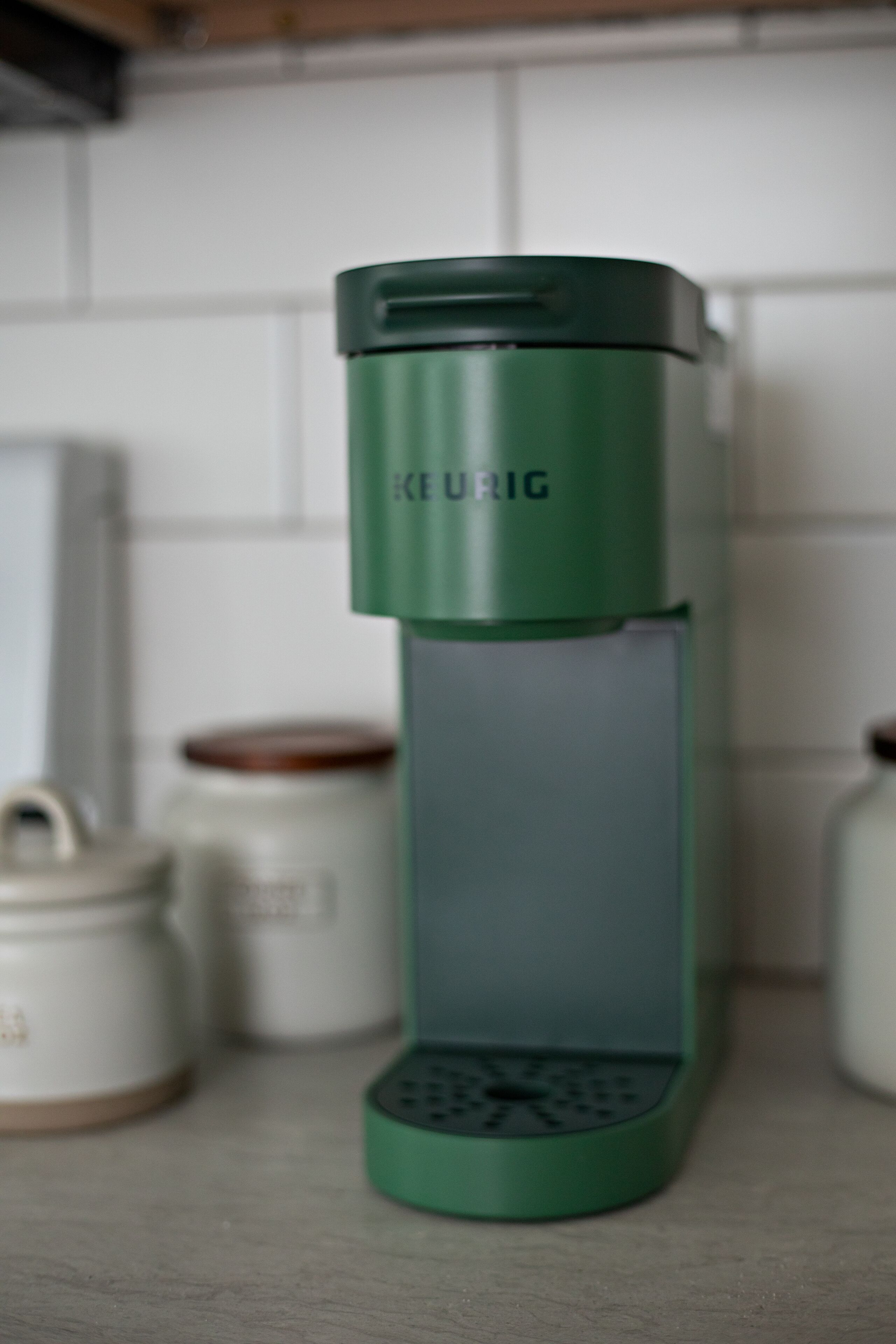 A green electric kettle on a kitchen counter.