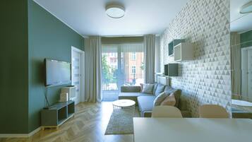 Comfort Studio Suite | Living area | 50-inch flat-screen TV with cable channels