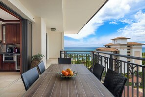 A balcony with a dining table, chairs, and a fruit bowl. - Ko Olina Beach Villas O1121: Luxurious Villa w/Golf Course & Ocean Views (Kapolei)