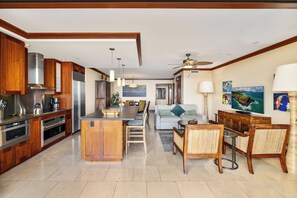 A spacious kitchen with wooden cabinets, stainless steel appliances, and a central island.
