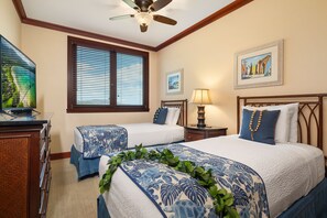 A hotel room with two beds, a ceiling fan, a window with blinds, a desk with a lamp, and artwork on the walls. - Ko Olina Beach Villas O805: Chef's Kitchen & Stunning Views (Kapolei)