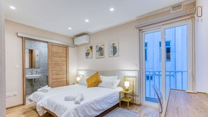 A modern bedroom with a bed, bedside tables, a window, and a view of the outside. - Luxury 3BR home in St Julians with private terrace (St. Julian`s)