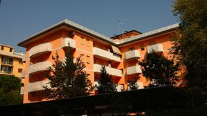 A multi-story building with balconies, likely an apartment complex.