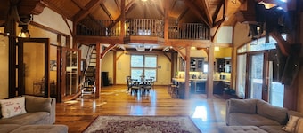 Vaulted beam ceilings, a huge rock fireplace, stream nearby, large campfire area