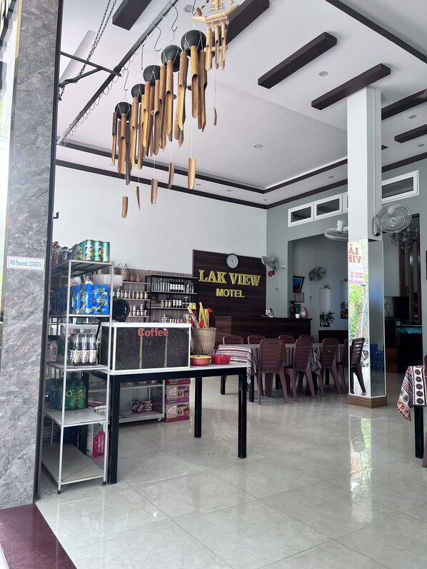 A hotel lobby with a coffee station, a reception desk, and a sign reading "LAK VIEW HOTEL". - LAK VIEW (Lak)