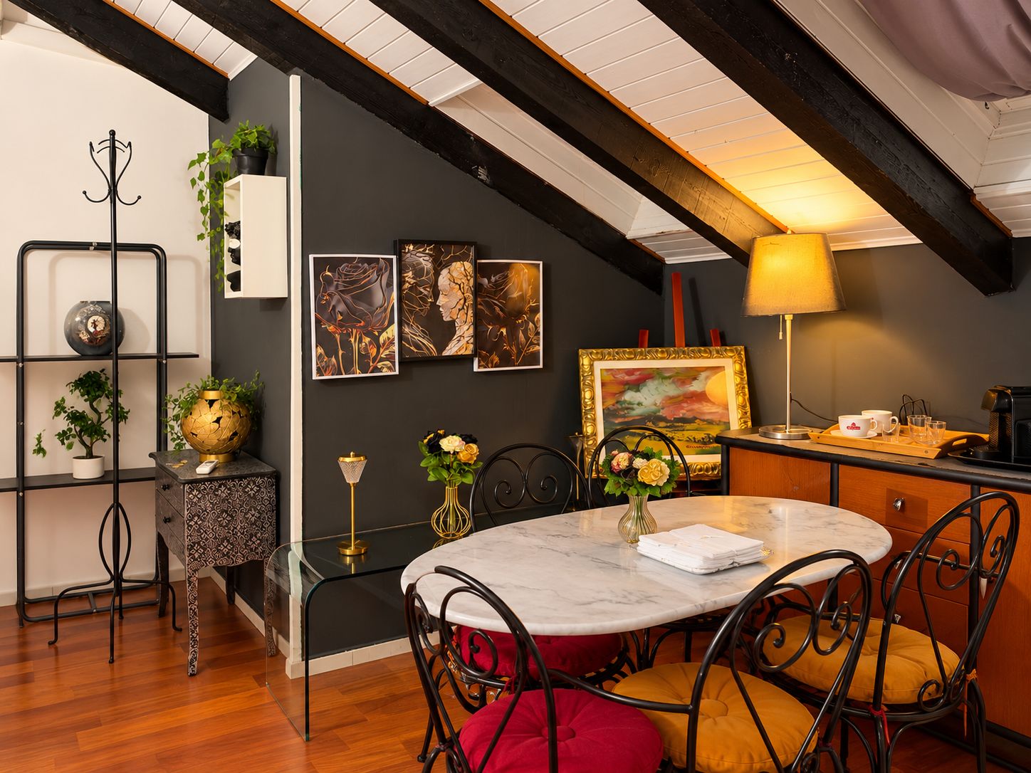 Uma sala de jantar com uma mesa redonda, cadeiras e um abajur.