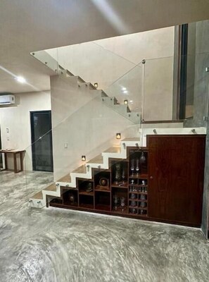 Stunning staircase with shelves and glass railing, blending functionality and style.