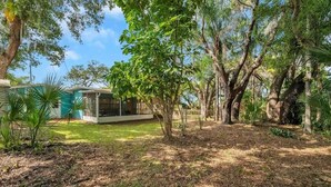 Una casa circondata da alberi e un prato.