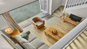 A modern living room with a sofa, armchair, coffee table, and a TV.
