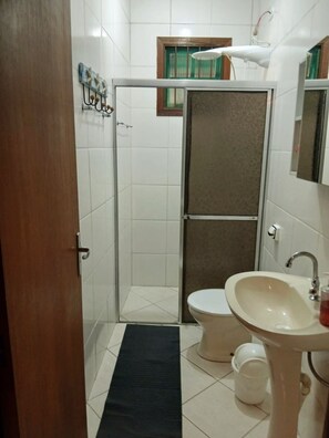 Shower, hair dryer, soap, toilet paper