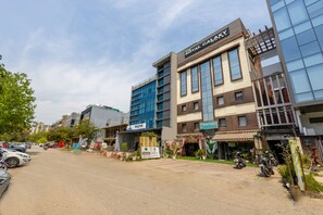 A hotel with a sign reading 'The Royal Galaxy' and 'Invictus' on the building.