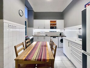 Enjoy meals together at the dining table for four, surrounded by modern kitchen amenities.