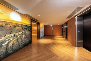 Stunning corridor with a large mural of a savannah landscape and polished floors.