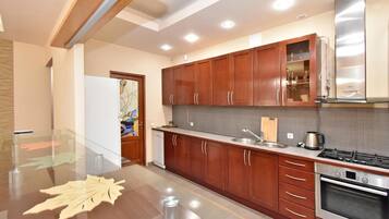 Departamento Deluxe | Cocina privada | Refrigerador, microondas, horno y parrilla de estufa