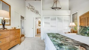 A bedroom with a bed, a dresser, a mirror, and a wall decoration. - Wailea Ekolu, #312 1 Bedroom Condo by RedAwning (Kihei)