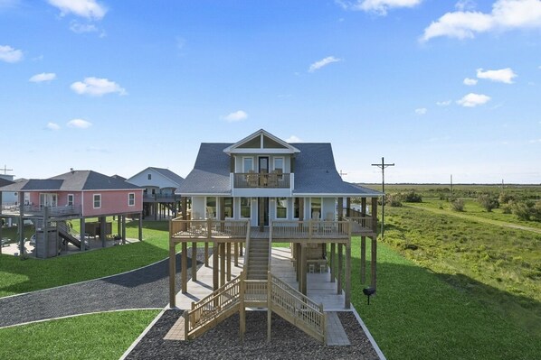 Enjoy a serene view from the upper-level balcony overlooking a well-maintained lawn.