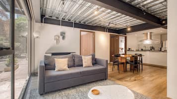 Deluxe Apartment | Living room | 50-inch Smart TV with digital channels, Netflix, streaming services