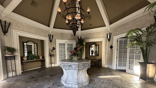 A spacious lobby with a central fountain, stone flooring, and a high ceiling with chandeliers. - Well Located Condo in Scottsdale near TPC Golf 2BR 2BA (Scottsdale)