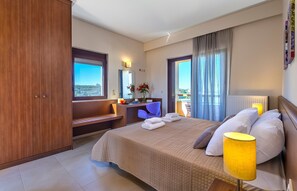 A hotel room with a bed, a desk, a chair, a window with a view, and a balcony. - Villa 'Margarita's 3' with Sea View, Wi-Fi and Air Conditioning (Chania)