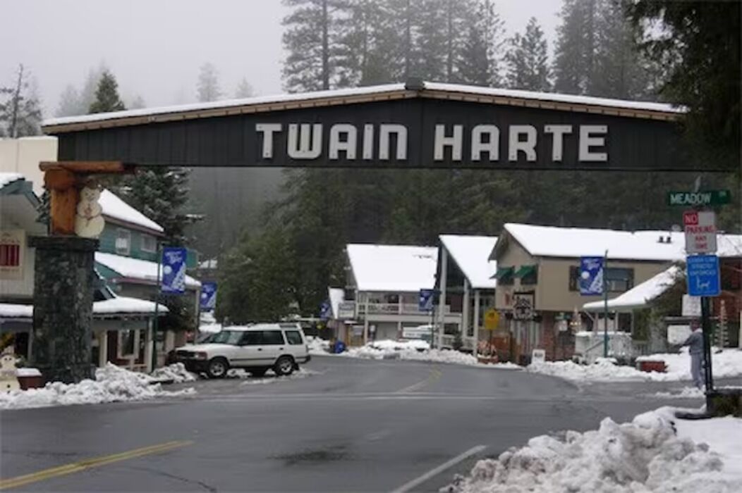 A building with a sign reading 'TWAIN HARTE' and a snow-covered street.