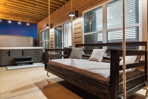 A wooden bed with a headboard, a bench, and a small table with a heater. - Lake View Condo with Private Hot Tub, $400 Free Daily Tickets & Unique Layout (Kimberling City)