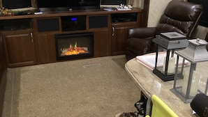 A living room with a fireplace, a television, and a comfortable seating area. - False Harbour Beach Paradise.
Directly on the beach.
worlds highest tides (Cape Forchu)