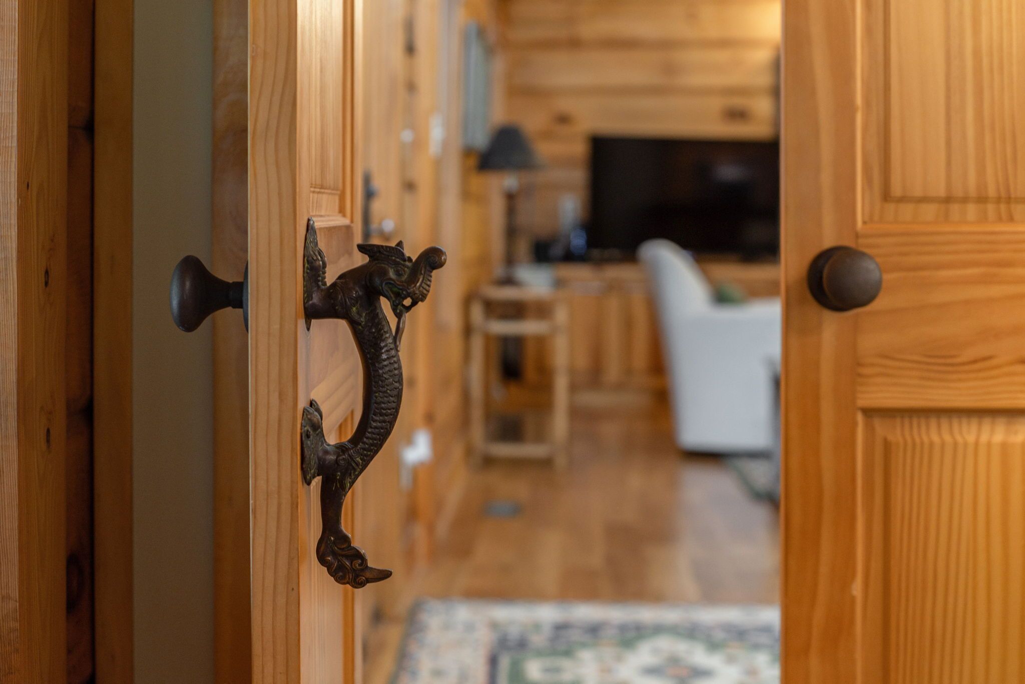 A wooden door with a decorative metal handle.