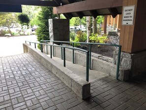 A concrete staircase with metal railings leading to a building entrance.