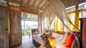 A room with a bed under a canopy, wooden walls, and a view of the outdoors. - Selini Hills (Labuan Bajo)