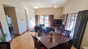 A spacious living area with a dining table, sofas, and a TV. - Find your stay peaceful and comfortable with luxury. Kids friendly (Scarborough)