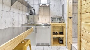 A compact kitchen with a built-in dishwasher, a microwave, and a wooden shelf unit. - 9 on the Ridge - 3 miles from Dollywood & Pet Friendly - Many repeat customers! (Pigeon Forge)