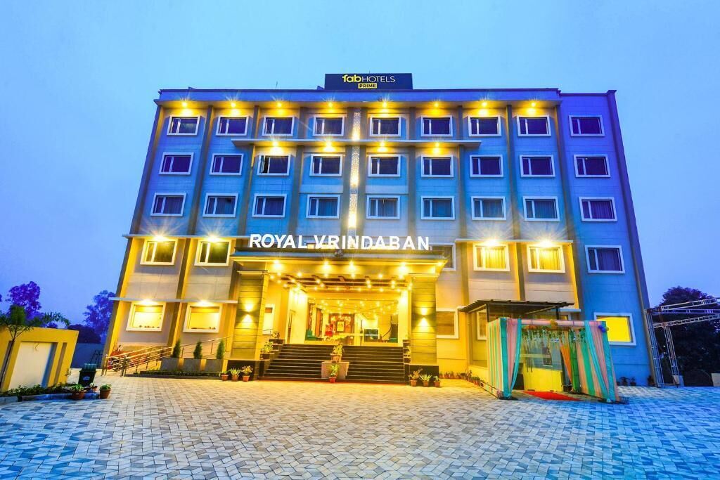 A multi-story hotel with a prominent entrance and a sign reading "ROYAL VRINDABAN".