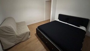 A bedroom with a bed, a chair, and a door. - Une vue Imprenable sur Metz ! (Metz)