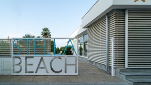A sign with the words "STELLA BEACH" in large letters, indicating the name of the location. - Residence Stella Marina (Cecina)