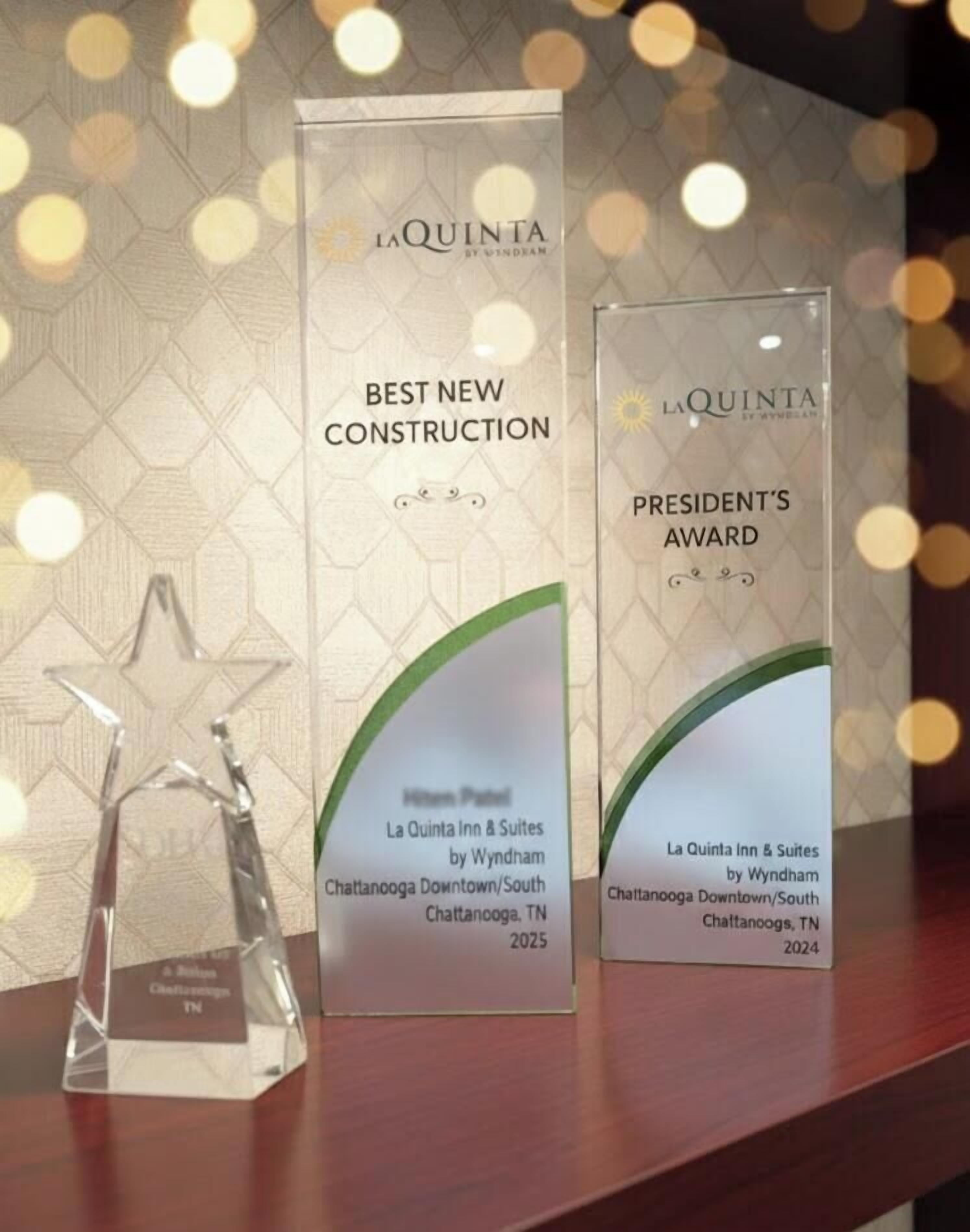 Two award plaques for La Quinta Inn & Suites by Wyndham in Chattanooga, TN, one for Best New Construction 2025 and another for President's Award 2024.