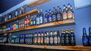 Shelves stocked with various bottles of alcohol, including brands like Guinness and Castle. - LE GRAND MARIE HOTEL (Dar es Salaam)
