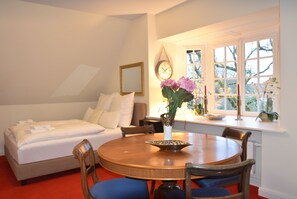 Enjoy a comfortable stay in this inviting room with a plush bed, dining area, and beautiful views.