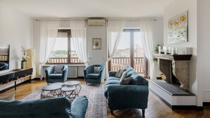 A living room with a fireplace, two sofas, a coffee table, and a TV.