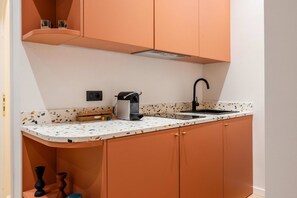 Fridge, stovetop, coffee/tea maker, cookware/dishes/utensils