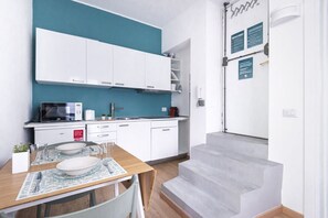 Fridge, stovetop, dishwasher, coffee/tea maker