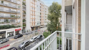 A multi-story residential building with balconies, a street view, and a shop named CREPA. - Easylife - Bright residence in Sant'Ambrogio (Milano)