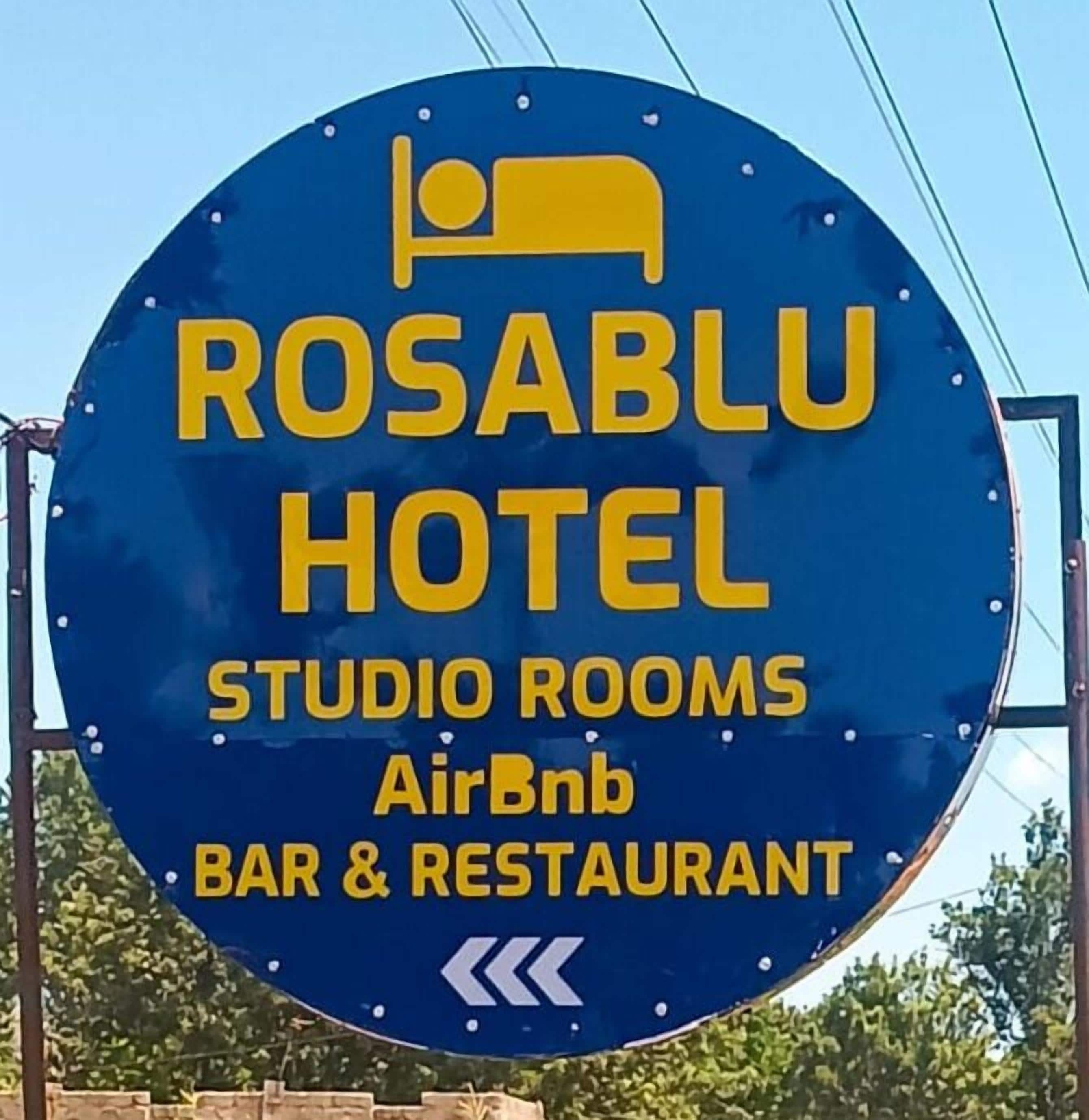 A sign for Rosablu Hotel advertising studio rooms, AirBnB, and a bar & restaurant.