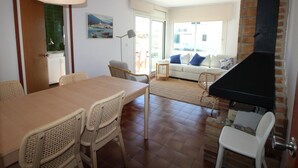 Un espace repas comprenant une table et des chaises, un canapé et une cheminée.