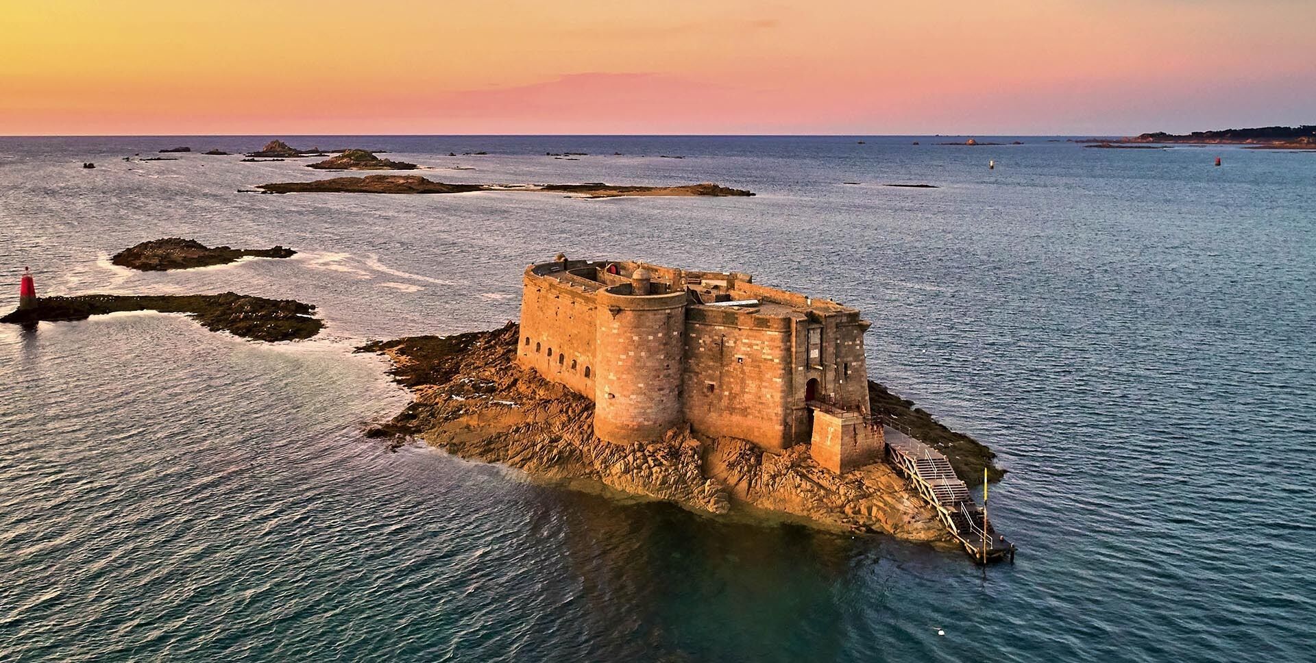 A coastal castle surrounded by water.