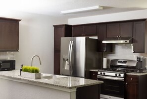 Coffee/tea maker, fridge, microwave, oven