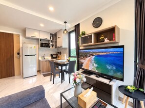 A modern apartment with a kitchen, dining area, and living room.