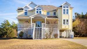 A two-story house with a front porch, a picket fence, and a driveway. - 2min Walk to Beach, Pool, Spa, Game Room, Big Yard (Corolla)