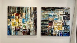 Two abstract paintings on a wall.