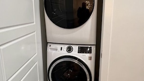 A laundry room with two stacked washing machines.